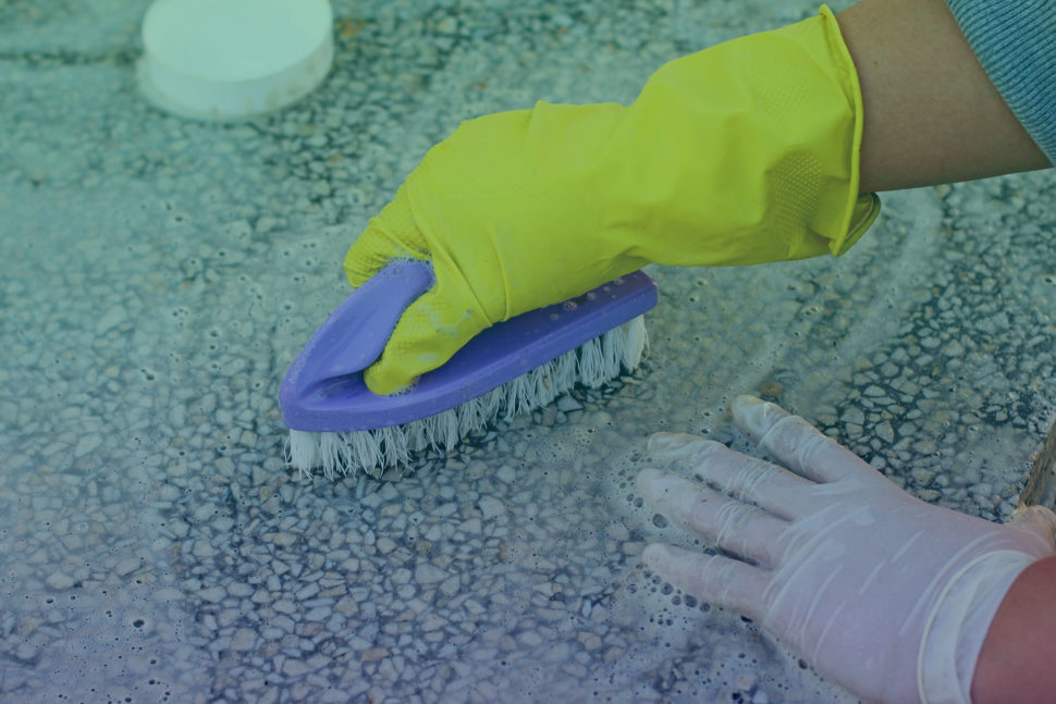 man cleans tombstones for vets