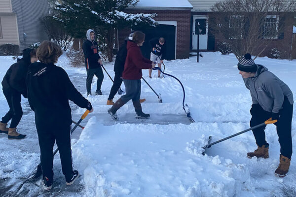 Football Team Helps Shovel Snow for the Elderly