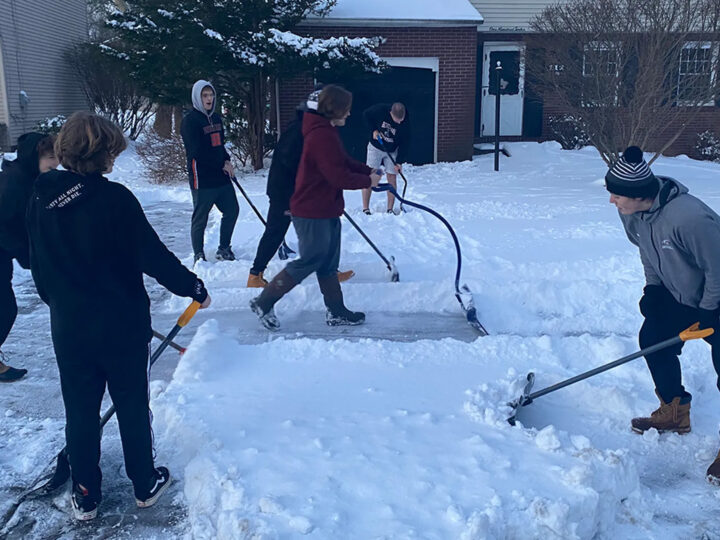 Football Team Helps Shovel Snow for the Elderly