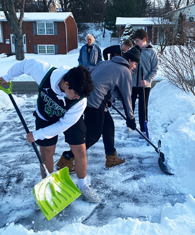 Football Team Helps Shovel Snow for the Elderly